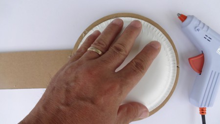 Paste the glue around on the back of a disk and stick the paper dish quickly.